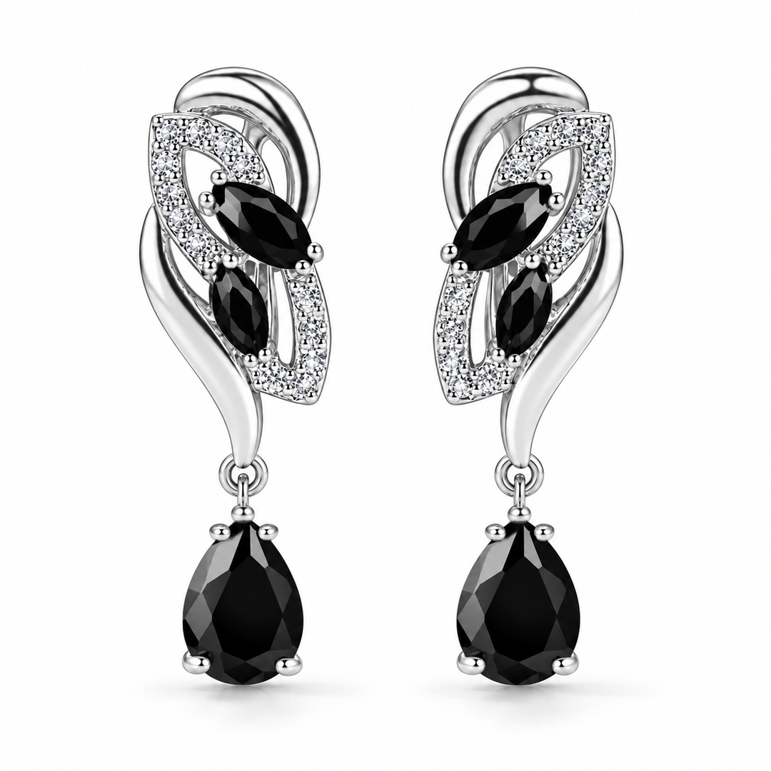 Iris Drop Earrings in Noir, a matching pair with a silver leaf-inspired setting and faceted pear drops on white