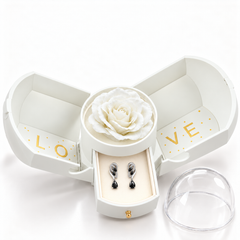 Iris Noir Silver earrings, one pair in the open white Rose Box drawer, with the matching rose and clear dome alongside