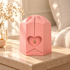 Closed pink Rose Box with sculpted crown and heart detail on pale stone