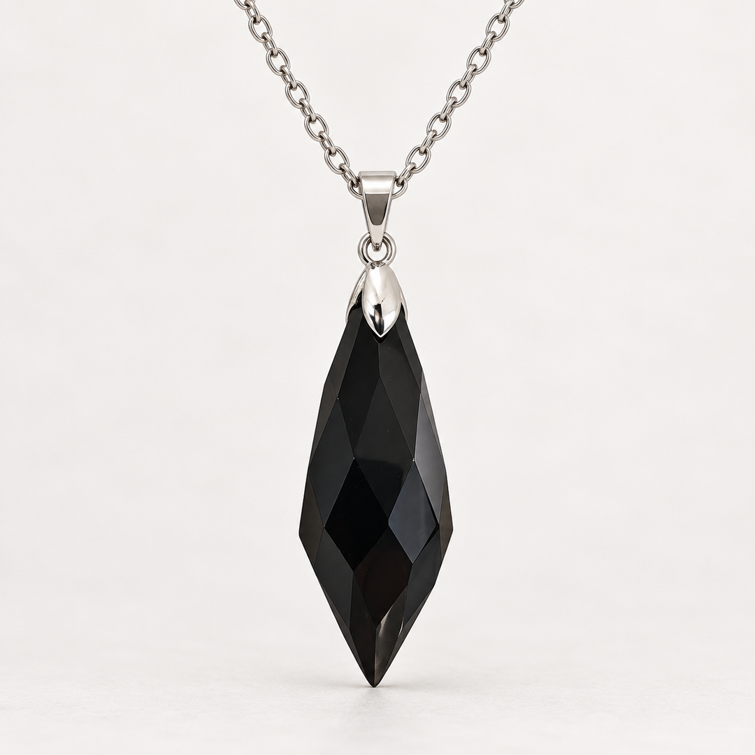 Meteor Black faceted pendant, centred silver-tone fitting and fine chain on a light background