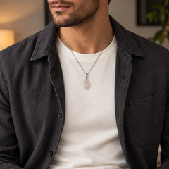 Meteor Blush necklace worn with an ivory tee with a charcoal jacket, showing its compact pendant and chain drop