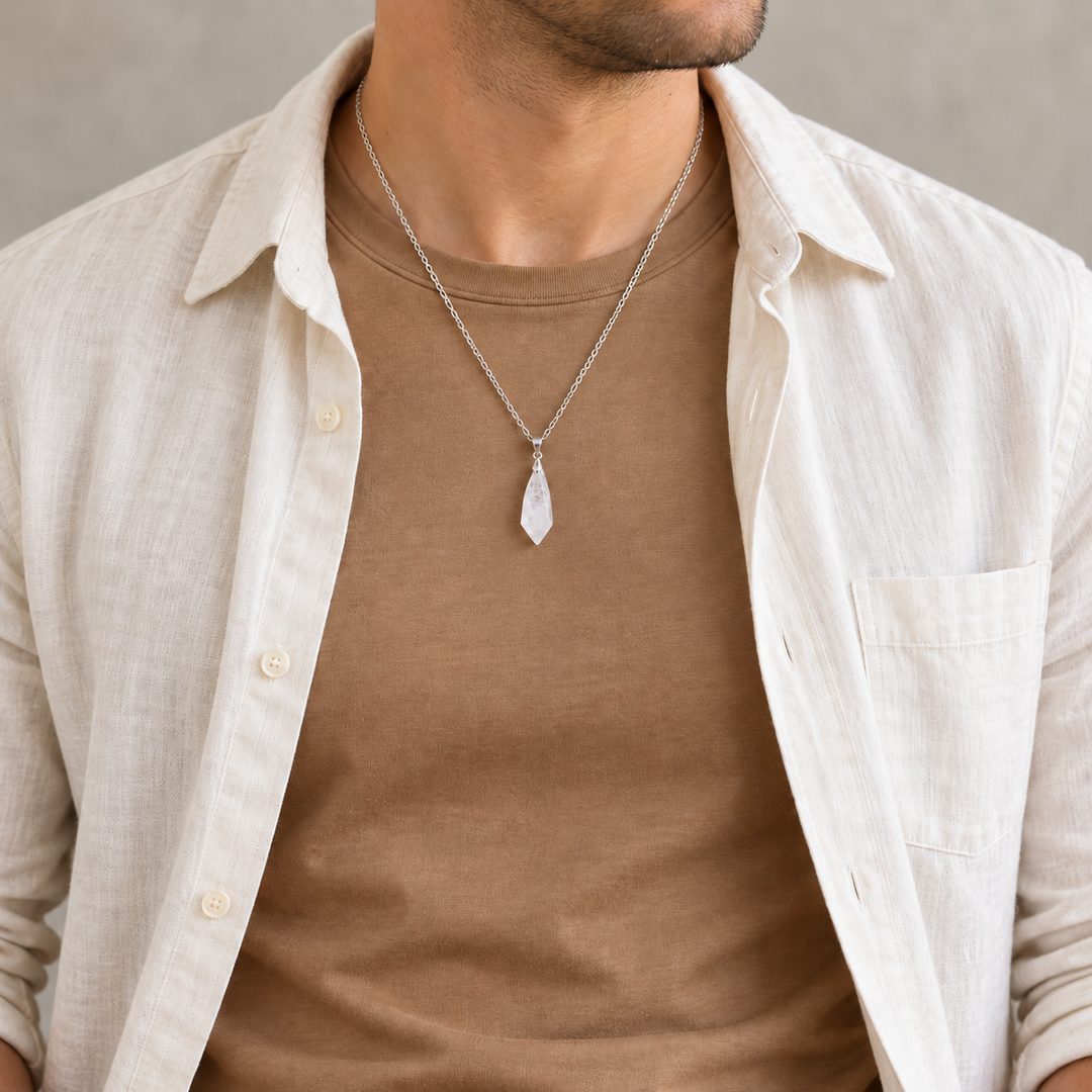 Meteor Clear necklace worn with a tan tee with a cream overshirt, showing its compact pendant and chain drop