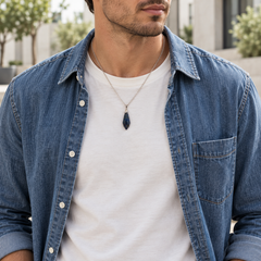 Meteor Cobalt necklace worn with a white tee with a denim overshirt, showing its compact pendant and chain drop