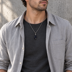 Meteor Midnight necklace worn with a charcoal tee with a grey overshirt, showing its compact pendant and chain drop