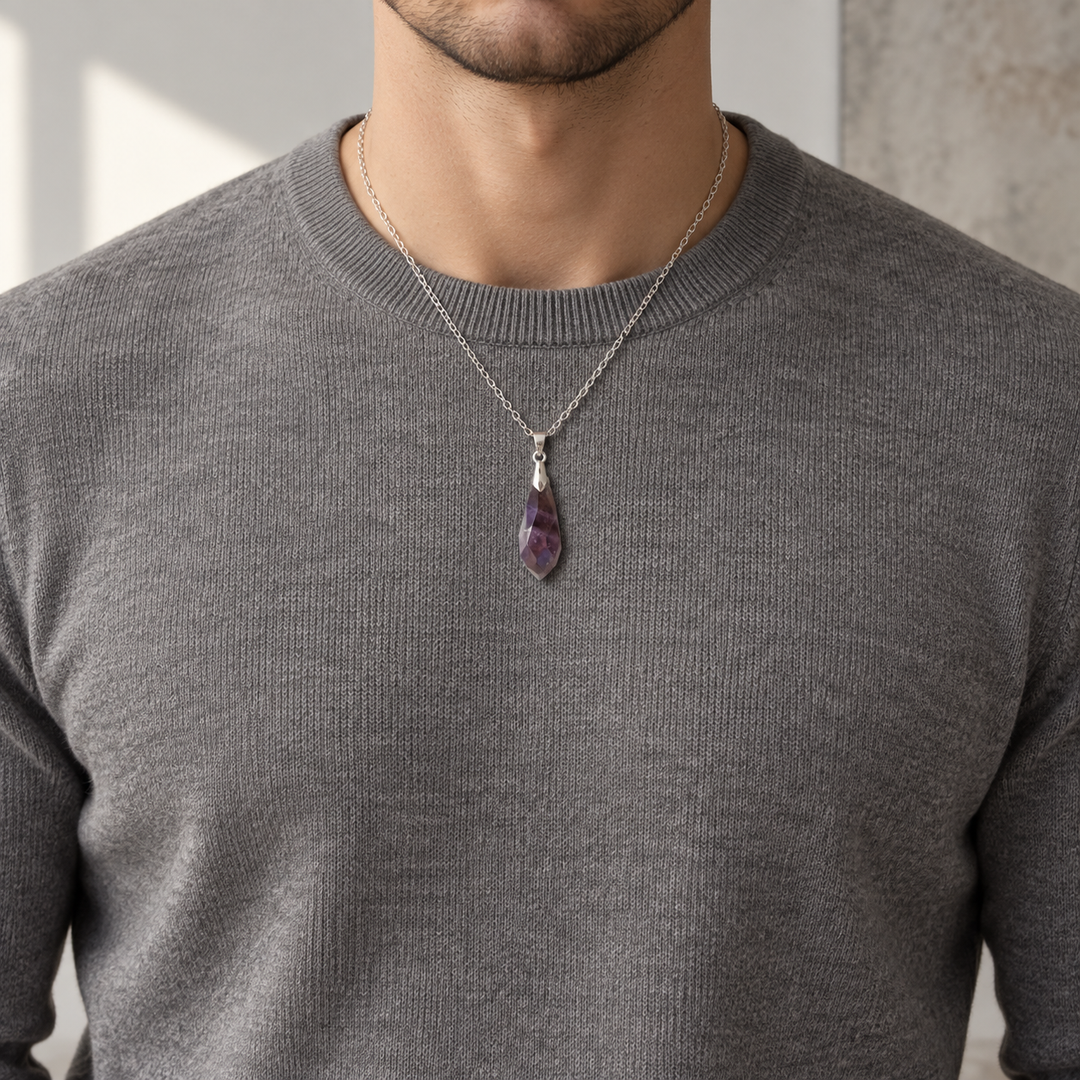 Meteor Violet necklace worn with a warm grey knit, showing its compact pendant and chain drop