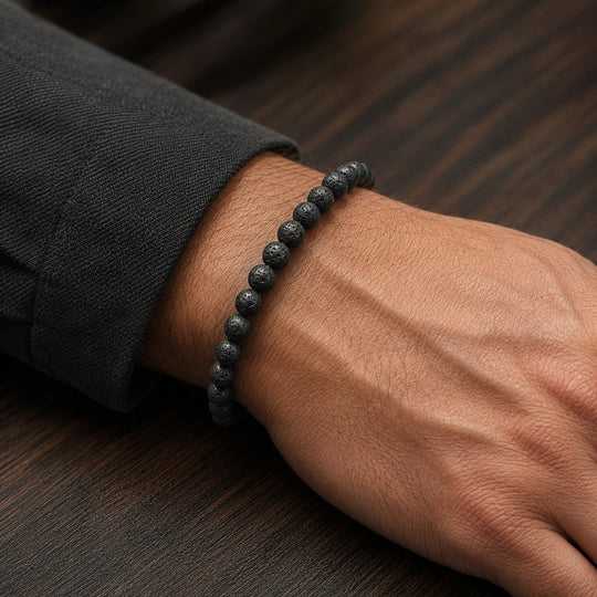 Origin Jet black lava stone bracelet worn with a tailored jacket