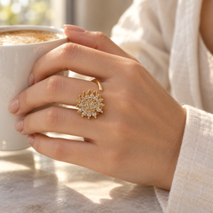 Petal Gold ring worn with an ivory linen sleeve at a sunlit café