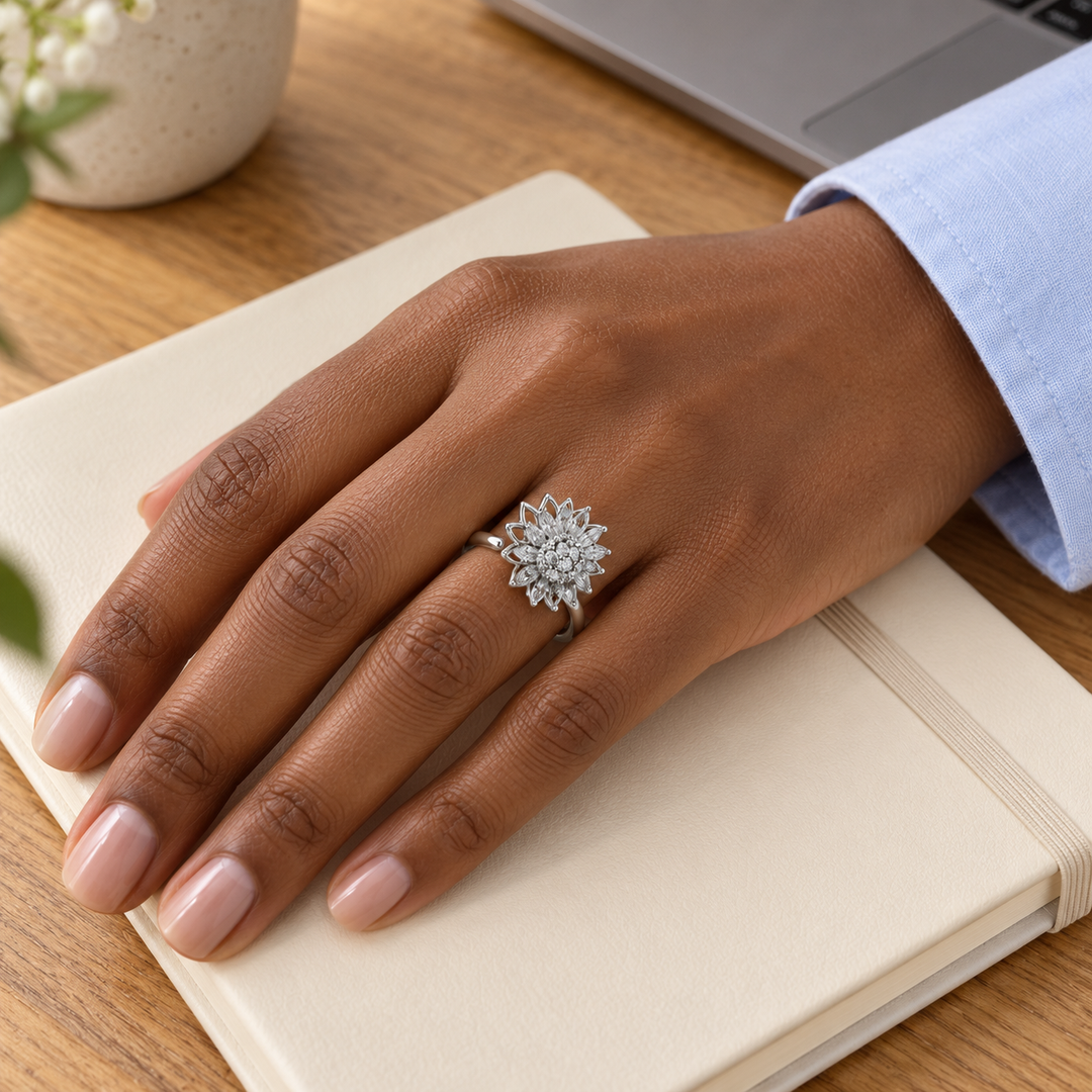 Petal Silver ring worn with pale blue shirting beside a notebook