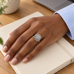 Petal Silver ring worn with pale blue shirting beside a notebook