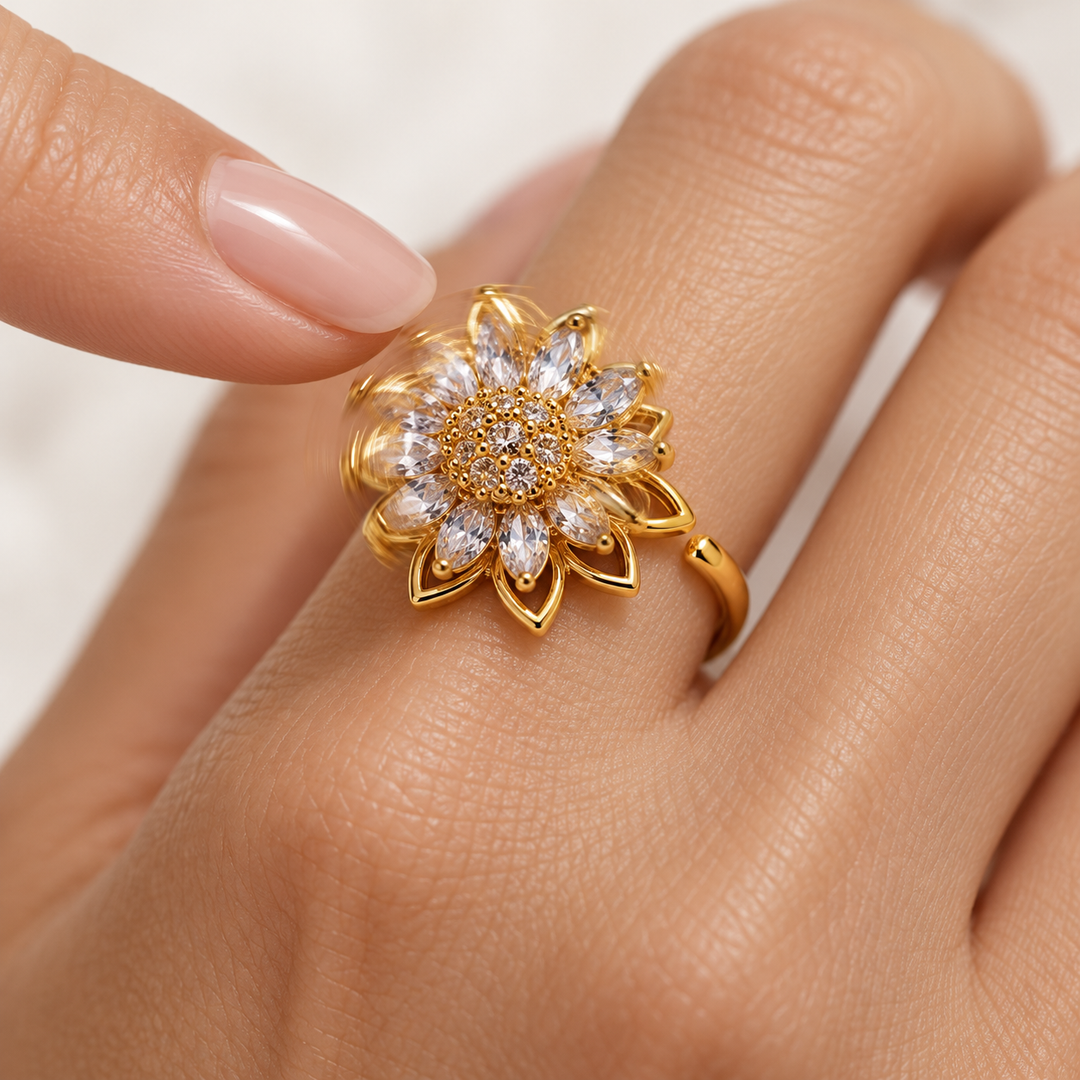 Petal gold flower turning with a gentle fingertip touch — motion illustrated