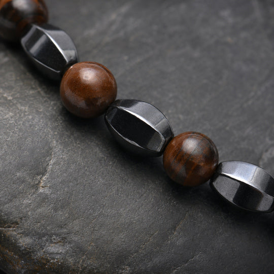 Prism Copper round stone and sculpted hematite macro detail