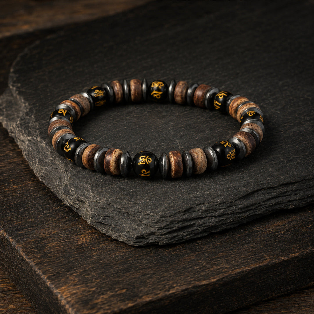 Relic Rune bracelet arranged on layered slate and dark timber
