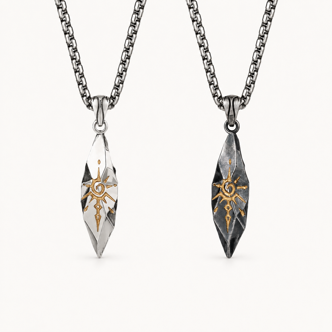 Sigil necklaces in Quicksilver and Graphite finishes on a warm white background