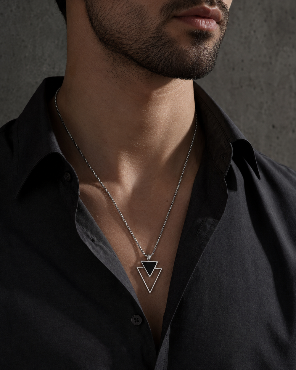 Man wearing the ZAFT Vertex silver and black triangle necklace