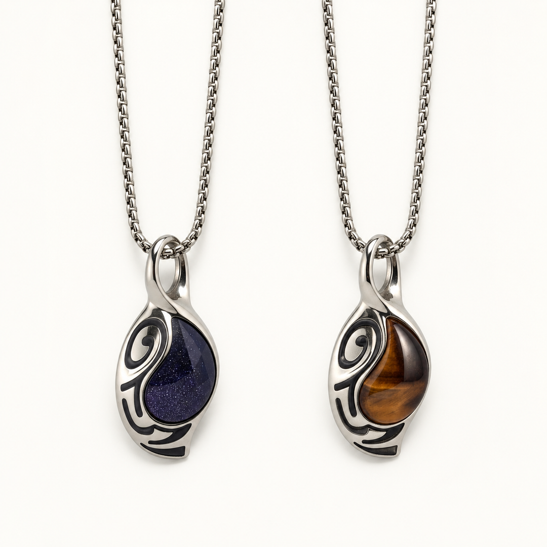 Vortex necklaces in Cosmos blue and Ember brown finishes on a warm white background