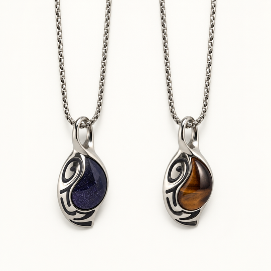 Vortex necklaces in Cosmos blue and Ember brown finishes on a warm white background