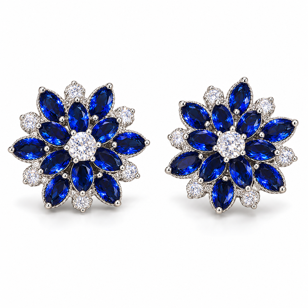 Dahlia flower stud earrings in Cobalt, showing the layered blue petals and clear centre stones.